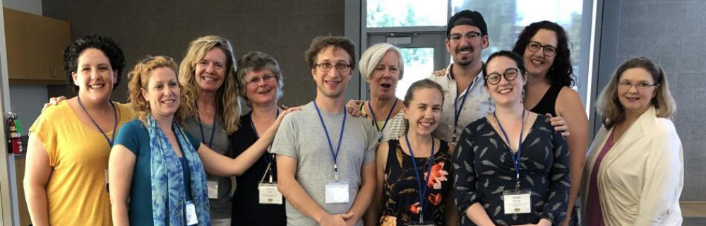 image of 12 adults smiling